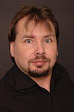 Portrait of a mid-aged man with brown hair and goatee