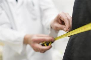 Doctor measuring the body of a patient.