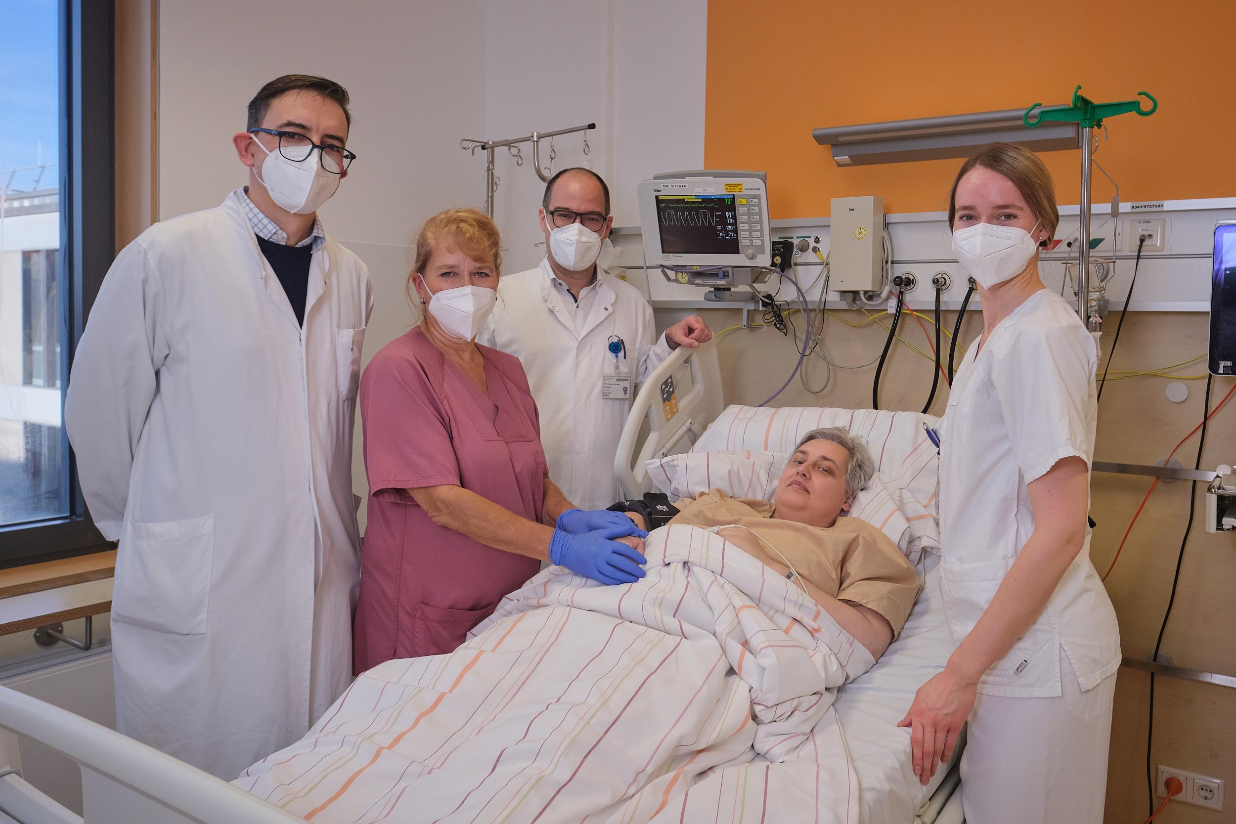 PD Dr. Vladan Vučinić, Krankenschwester Birgit Walther, Prof. Klaus Metzeler und Dr. Marie Jung (v. l.) bei der 300. CAR-T-Zell-Therapie am  Bett der Patientin Ines Kortmann.